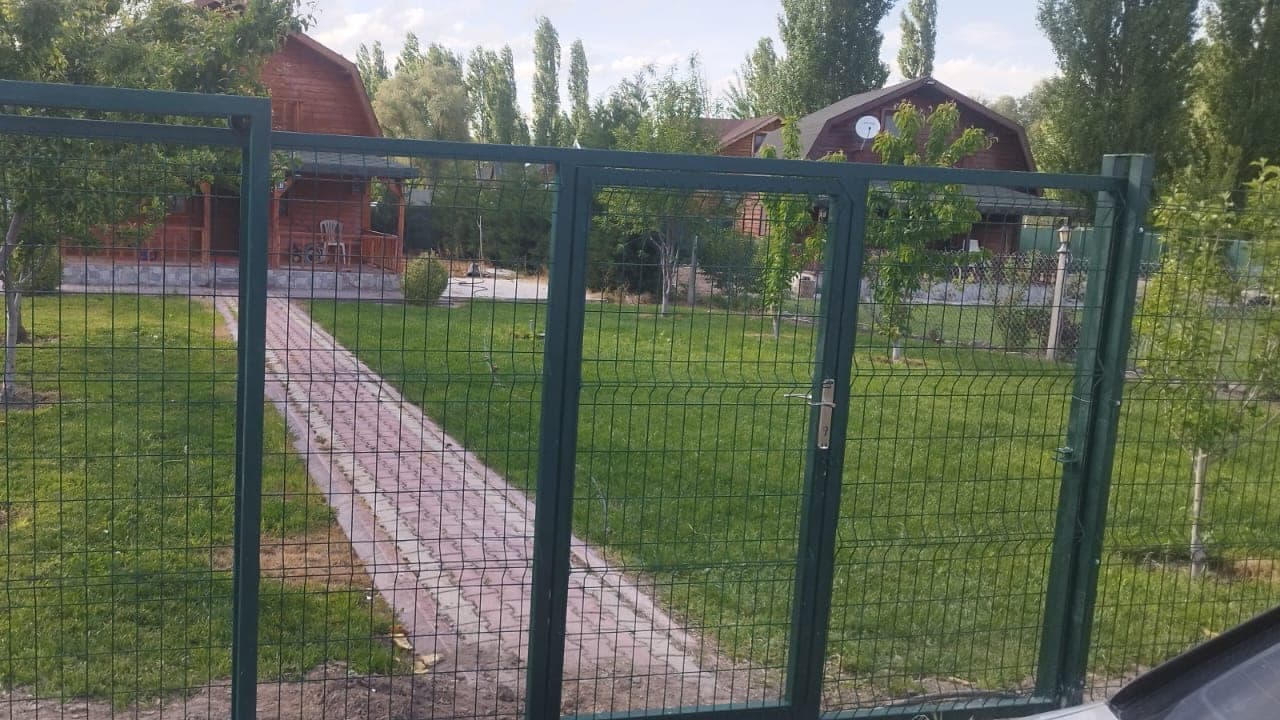 Ankara'da bir bahçe çevresine kurulmuş yeşil panel çit ve yürüyüş kapısı